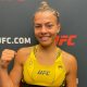 Com o punho erguido, Luana Santos comemora sua estreia com vitória no UFC