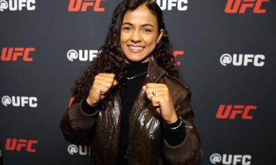 De punhos cerrados e sorriso no rosto, Natália Silva posa para foto no media day do UFC 324