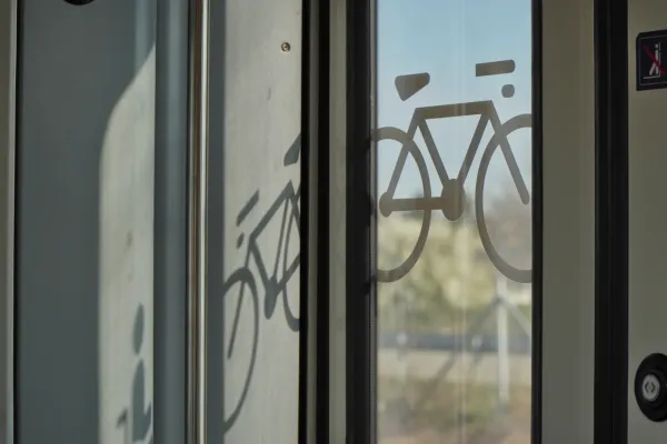 Símbolo de una bicicleta en la puerta de vidrio de un tren en Belgrado, Serbia, que indica transporte de bicicletas.