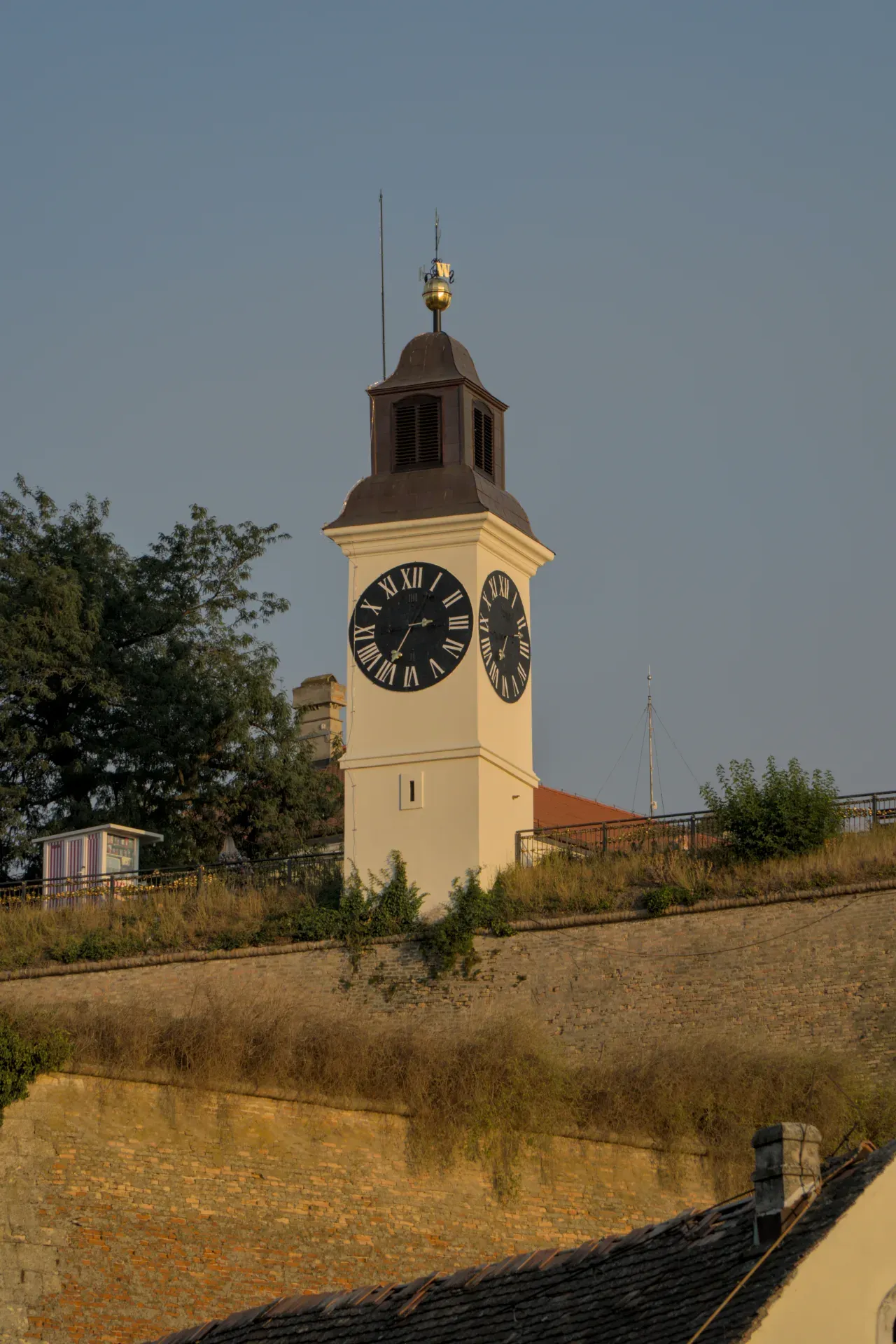 The clock of Petrovaradin Fortress in Novi Sad, Serbia, in the evening light at sunset.