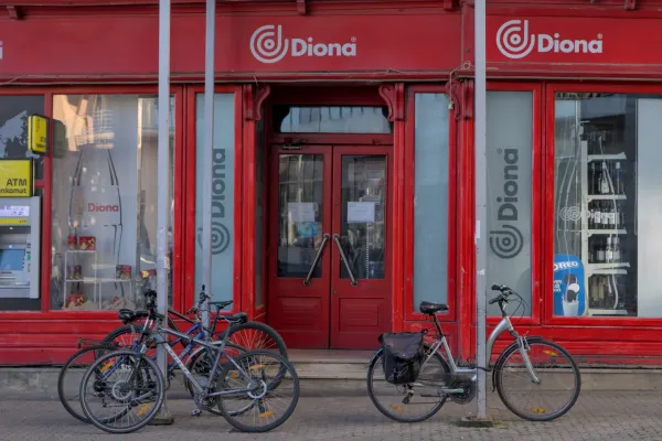 A vibrant red facade of a shop in Zagreb, with several bicycles parked in front, captured in landscape format.