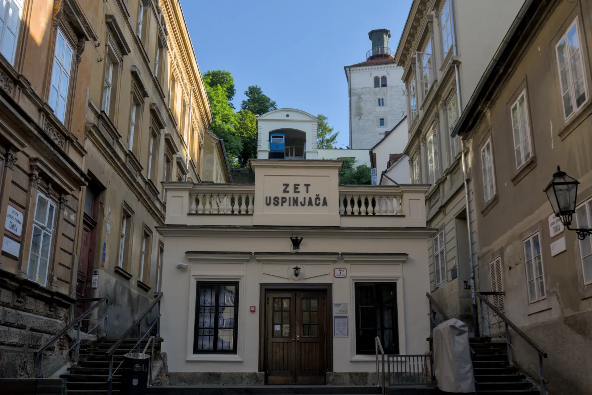 The historic funicular of Zagreb, known as Uspinjača, with its classic facade and surrounding buildings in daylight.