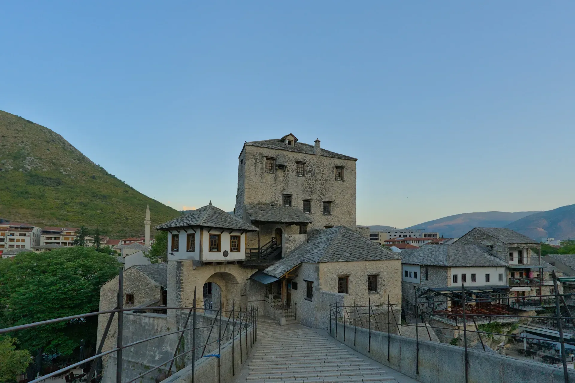 Vue du Stari Most et des tours à Mostar, Bosnie-Herzégovine, avec un ciel clair en arrière-plan.