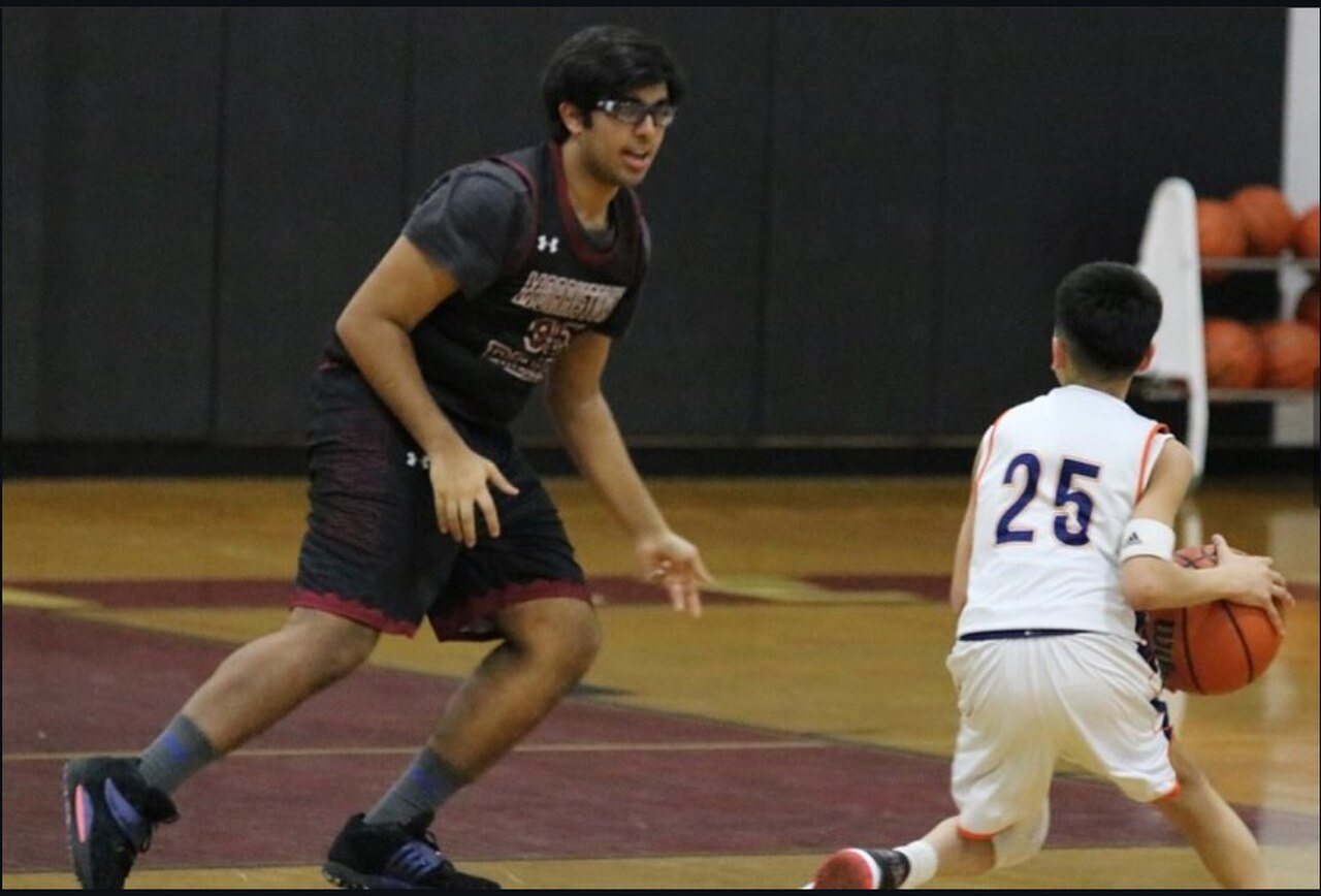A photo taken during a high school basketball game in 2024, showing the wide differences in physical maturity between opposing players