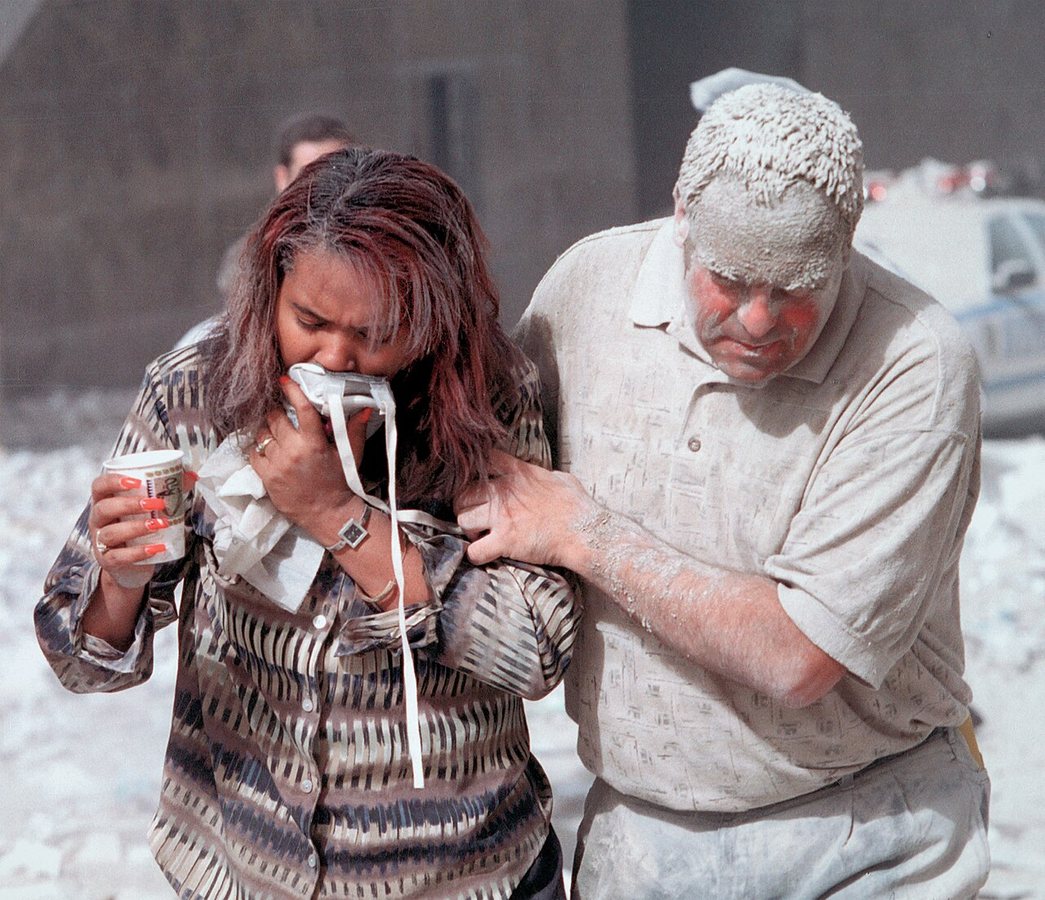 Survivors covered in dust after the collapse of the World Trade towers; a photograph of another dust-covered victim, Marcy Borders, later gained wide attention