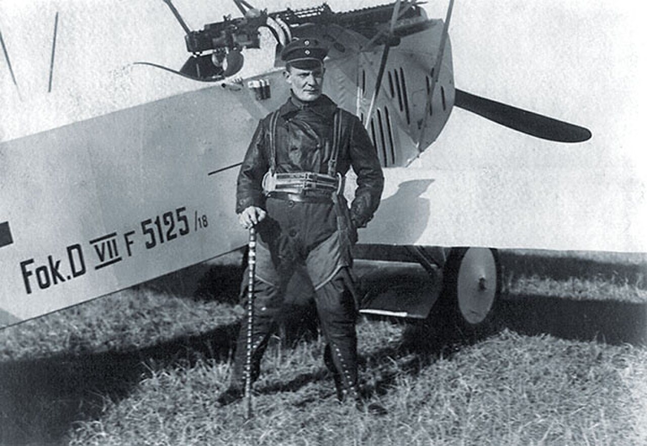 Göring in 1918 as commander of Jagdgeschwader 1 beside his Fokker D VII (F) 5125/18, holding a walking stick once owned by Manfred von Richthofen