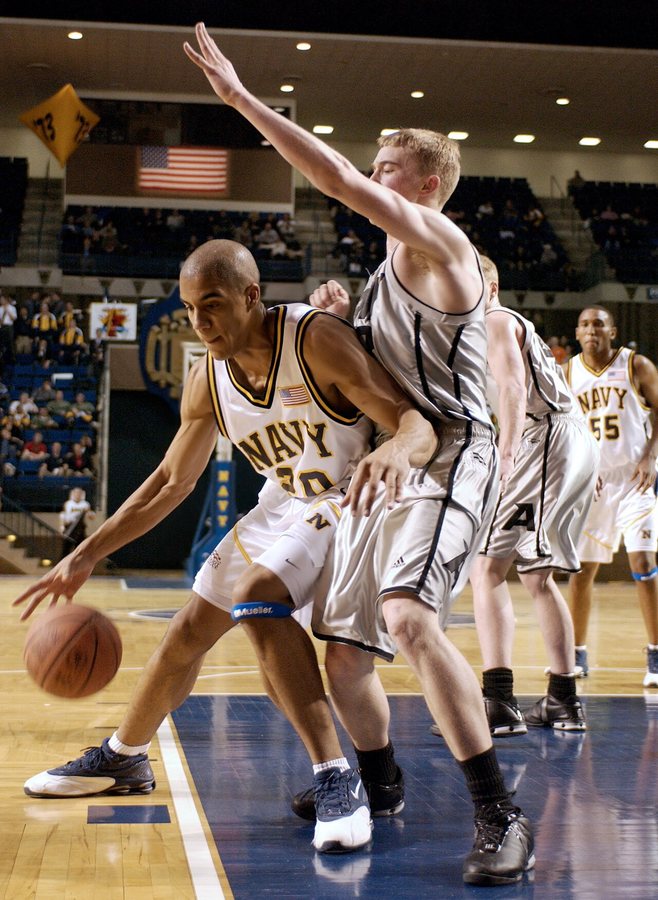 A U.S. Naval Academy (Navy) player, left, posts up a U.S. Military Academy (Army) defender