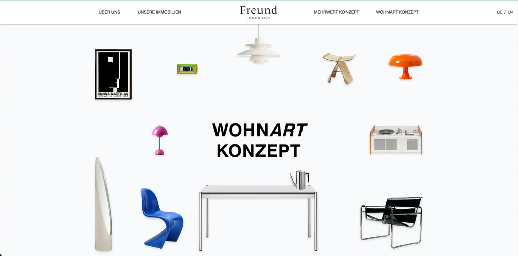 White website of the real estate company Freund focusing on "Wohnart Konzept" with various modern designer furniture and lamps arranged in a circular layout around the text.