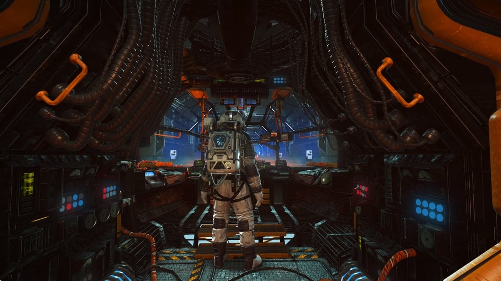 An astronaut stands in a cockpit.