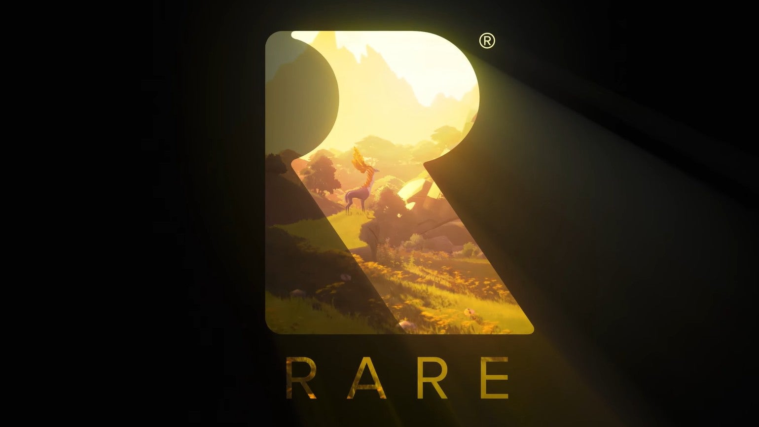 Image Of A Large R With A Deer Standing In A Countryside Setting Inside It. The Studio Name Rare Is Written Below