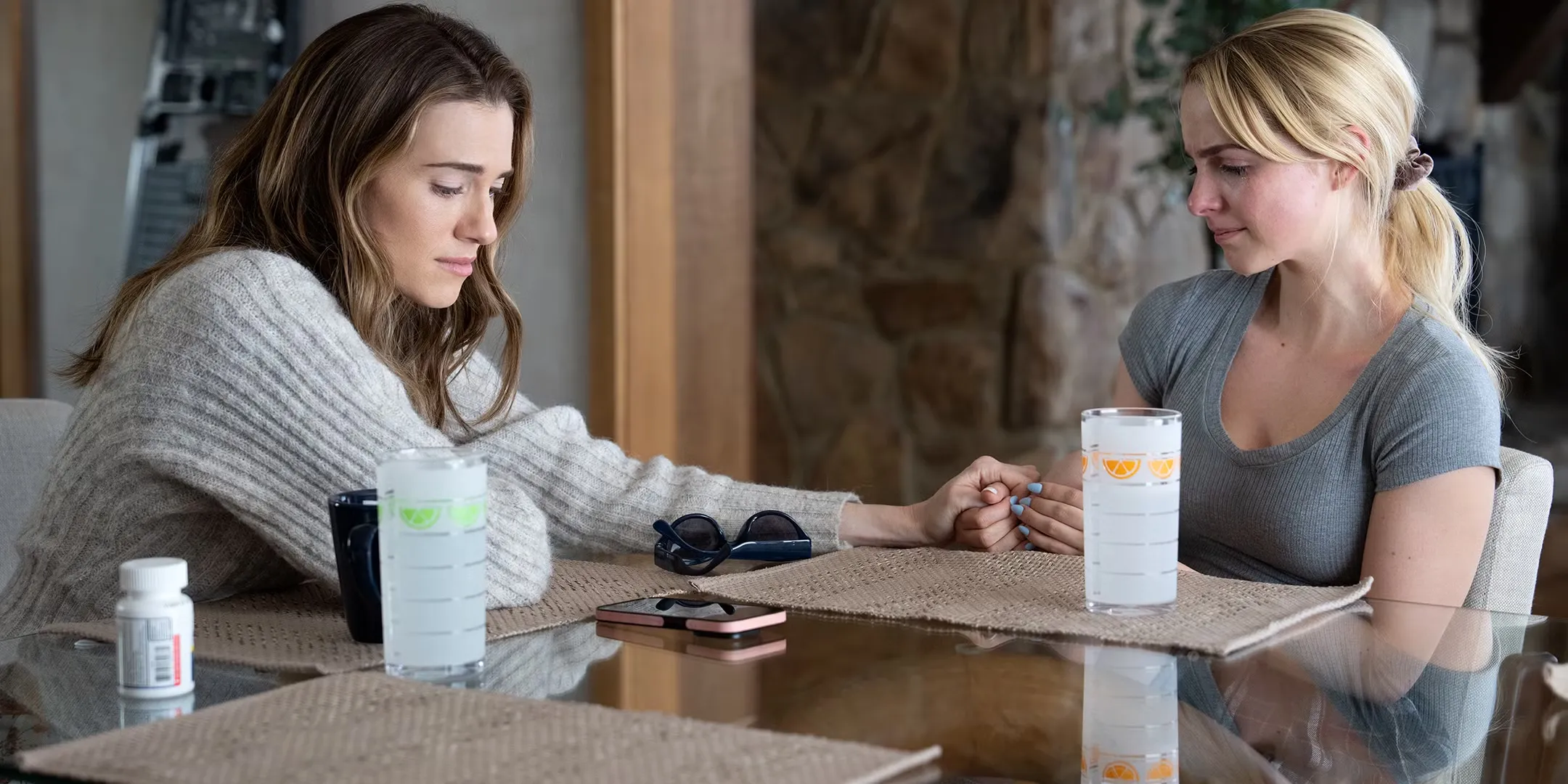 Allison Williams' Morgan and Mckenna Grace's Clara holding hands while looking sadly in Regretting You