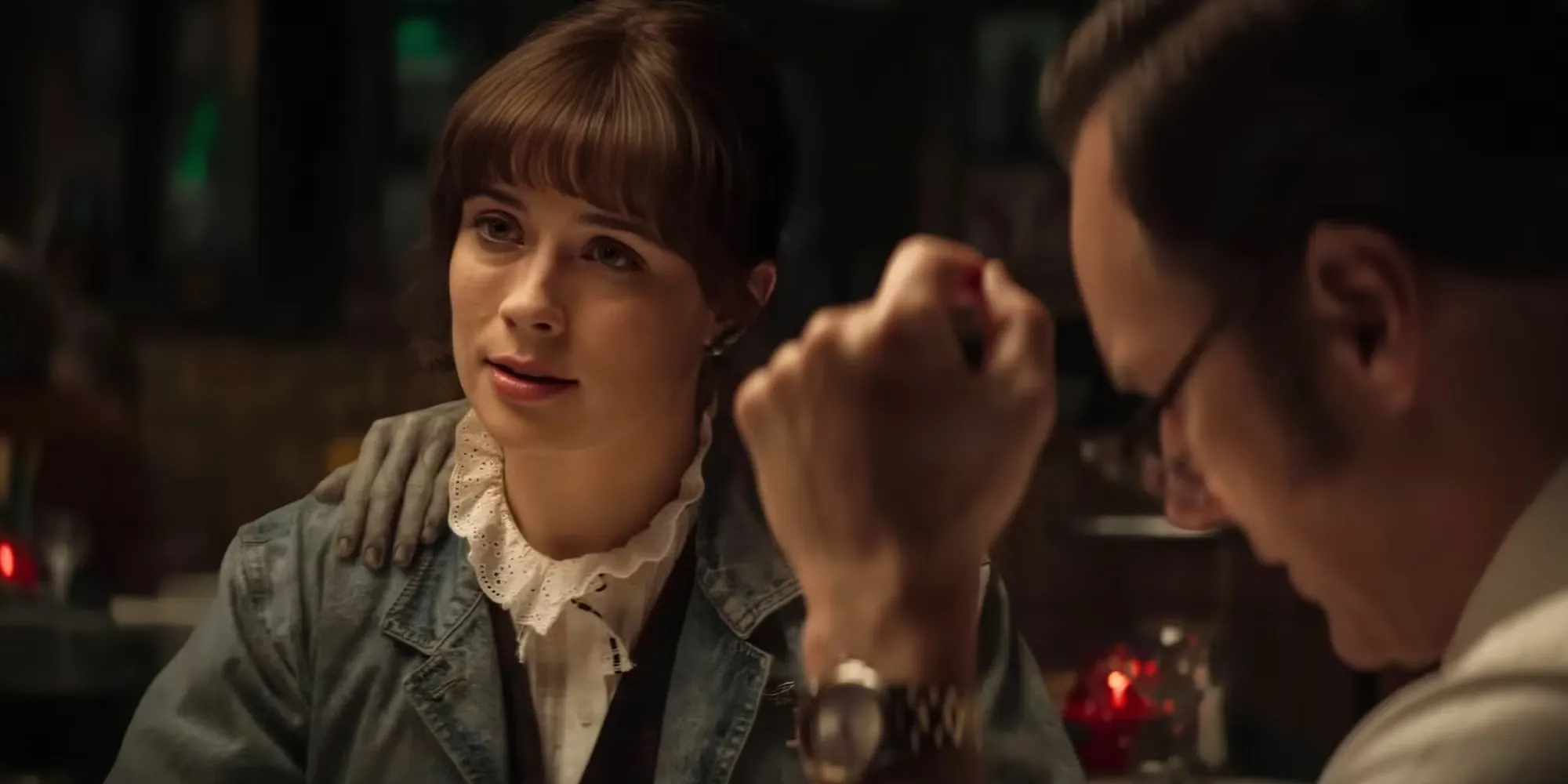 Judy Warren looking across the table at a restaurant in The Conjuring: Last Rites.