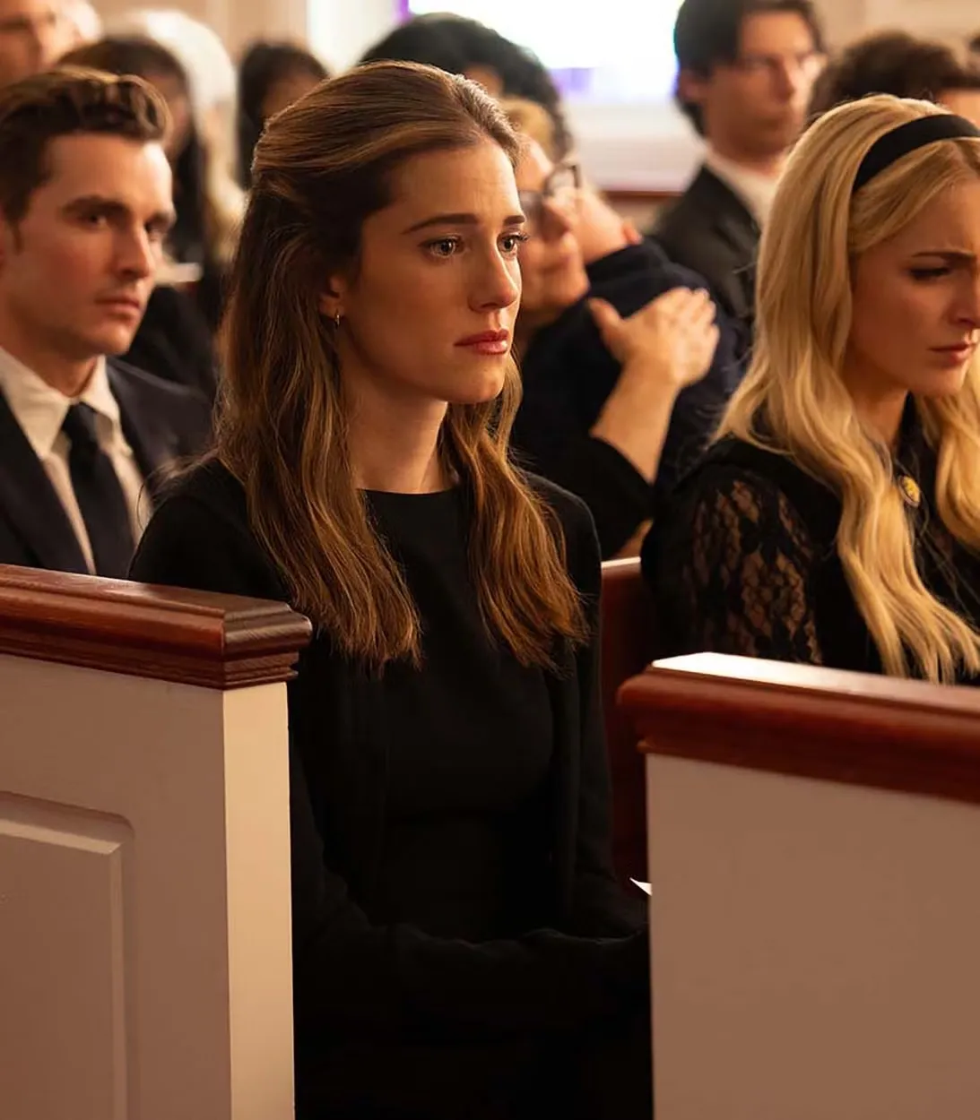 Allison Williams' Morgan, Mckenna Grace's Clara and Dave Franco's Jonah all looking sad in church pews in Regretting You