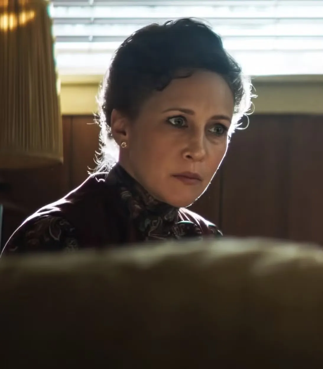 Lorraine looking suspiciously at a bed in The Conjuring: Last Rites