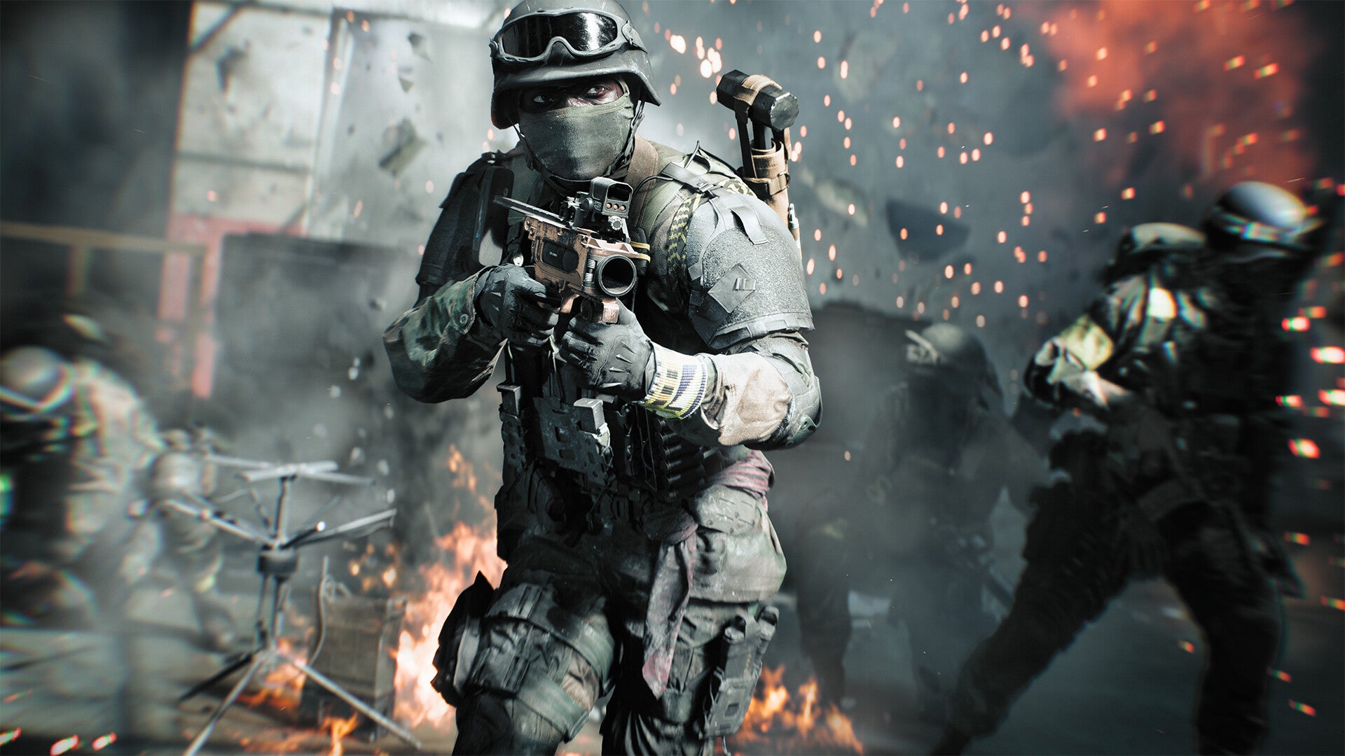 A soldier in Battlefield 6 moves towards the camera, holding a small weapon, which is drawn. Another soldier runs to his right, there are sparks flying everywhere and a small fire in the background in front of a crumbling buildings.