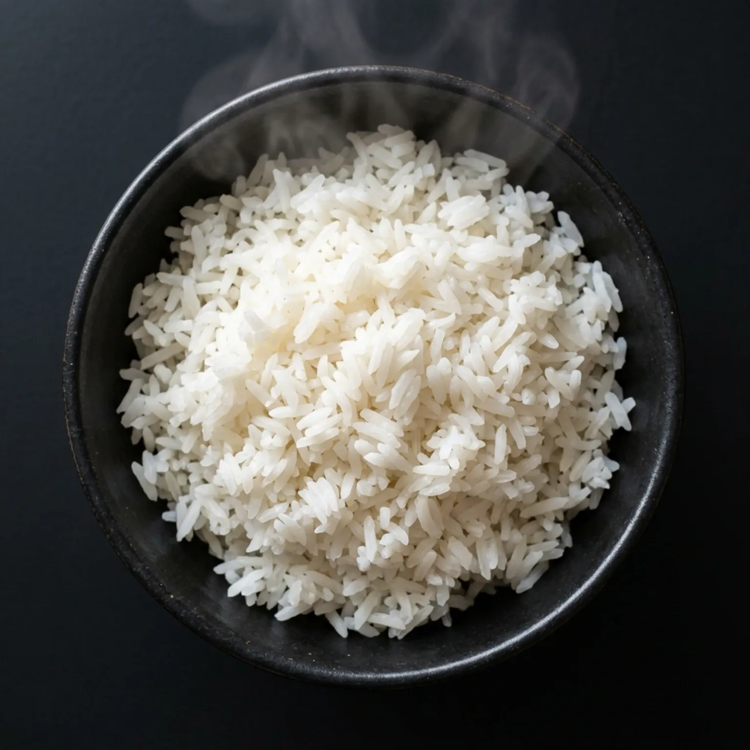 A steaming bowl of fluffy, white Jasmine long grain rice
